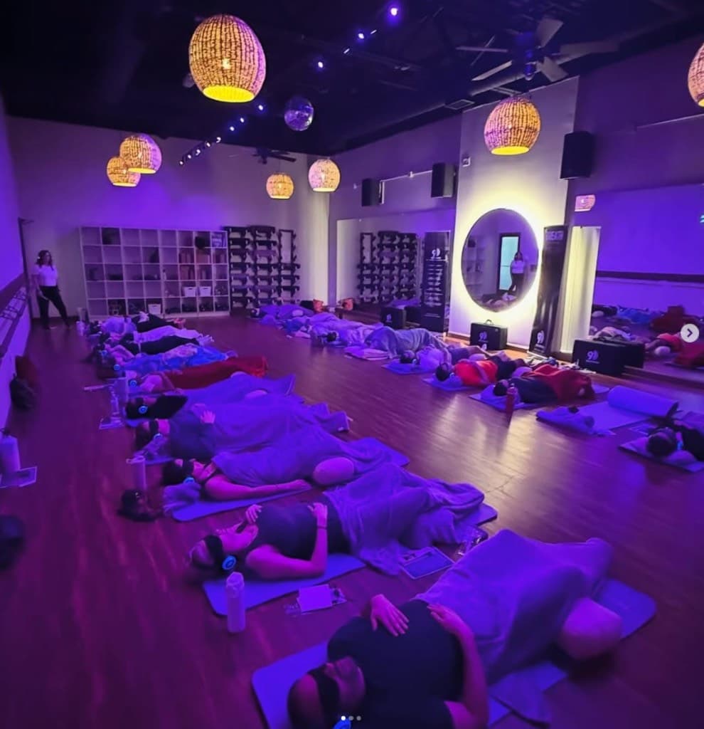 Full room group 9D Breathwork with participants on mats