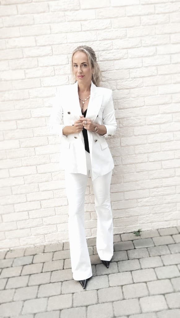 Liina Täht, travelling 9D Breathwork facilitator in a white suit